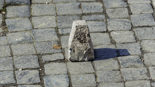 Typical pavement of the streets of Rome with cobblestone (sanpietrini). In view of one of the stone slopes